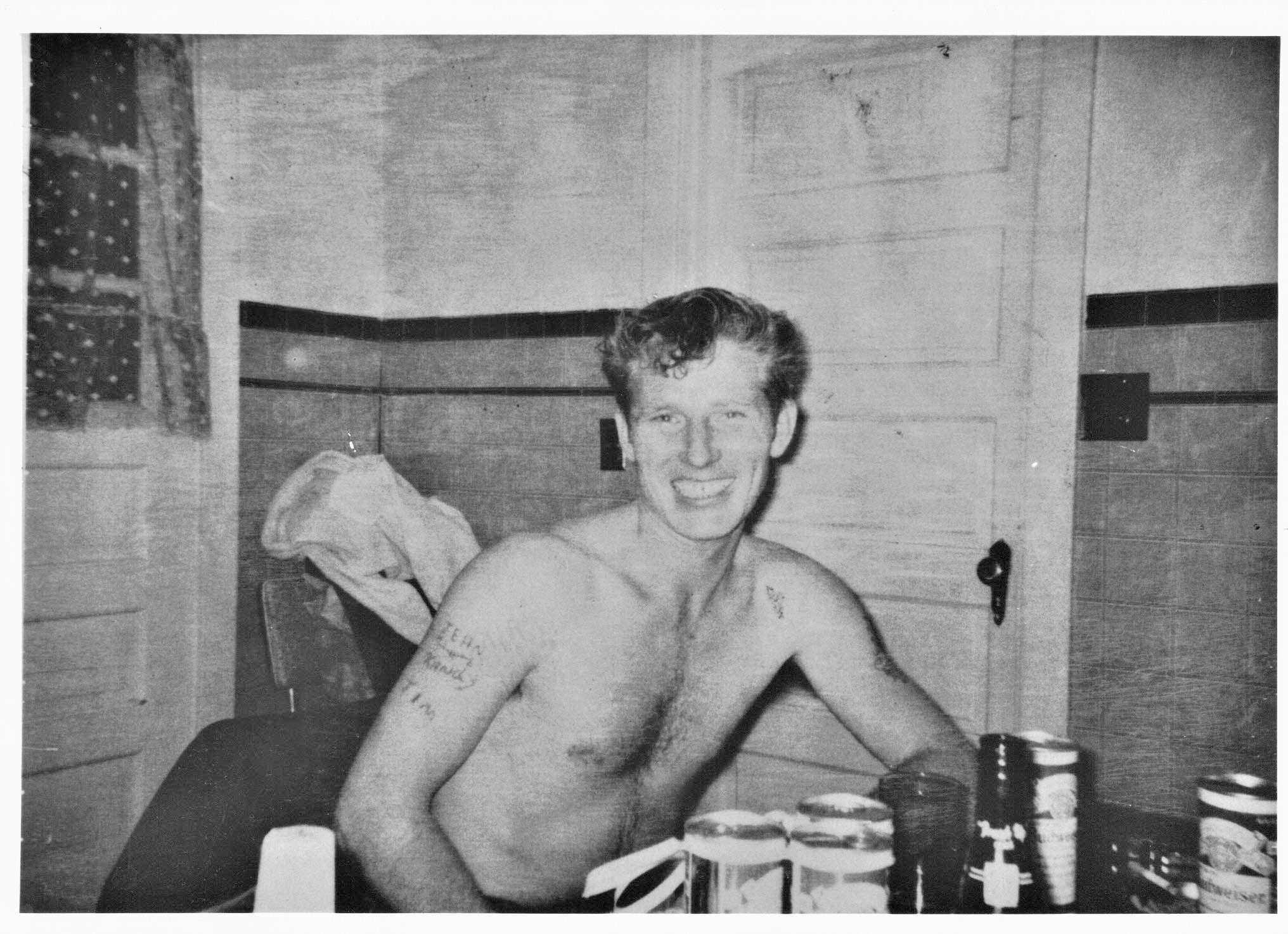 James Monroe sitting at the kitchen table among beer and booze bottles