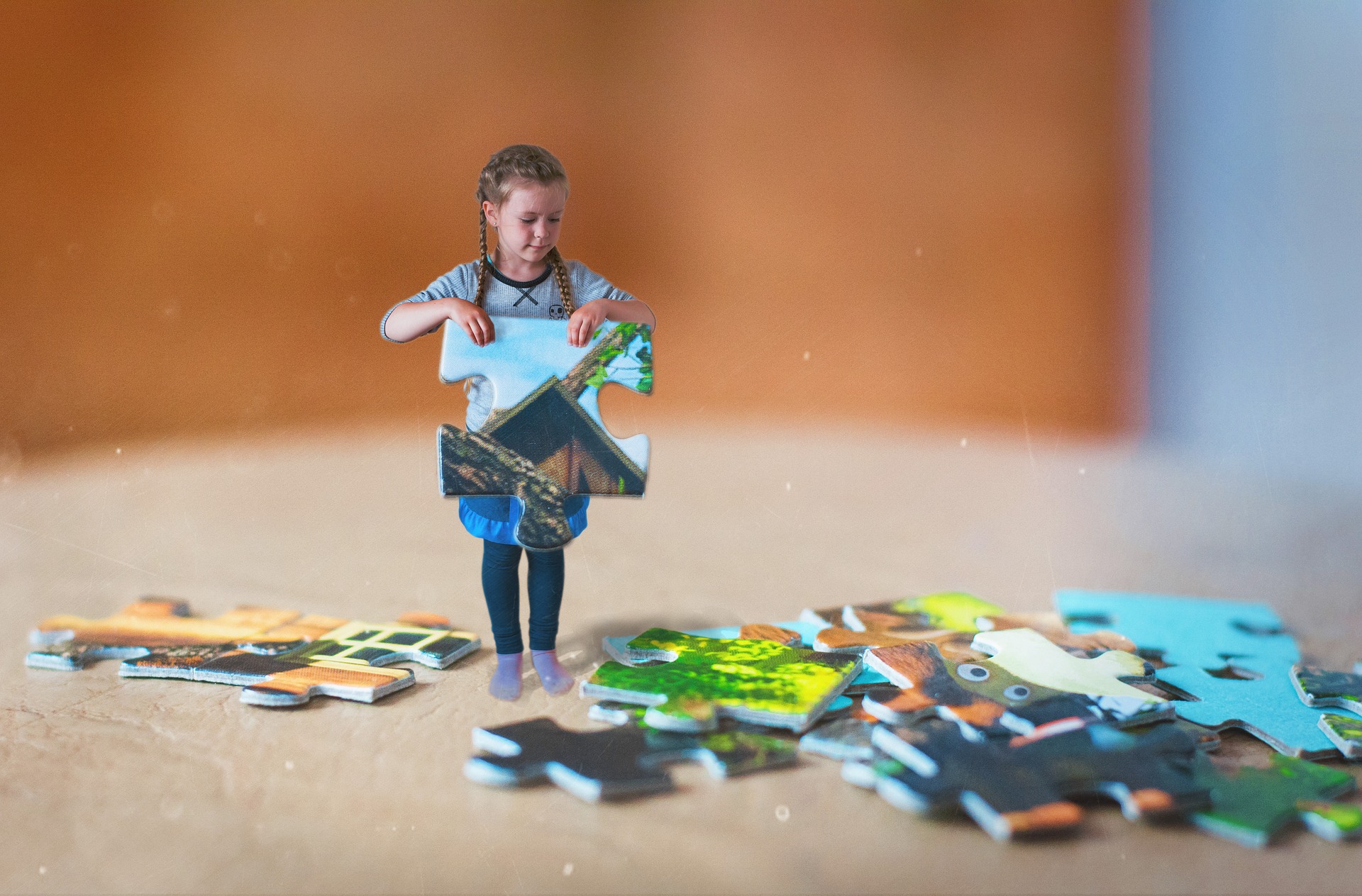 Child holding a puzzle piece of home